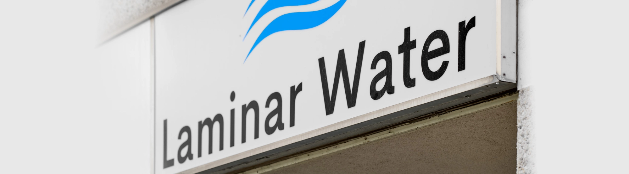 Laminar Water company sign on the exterior of a containerized water treatment facility